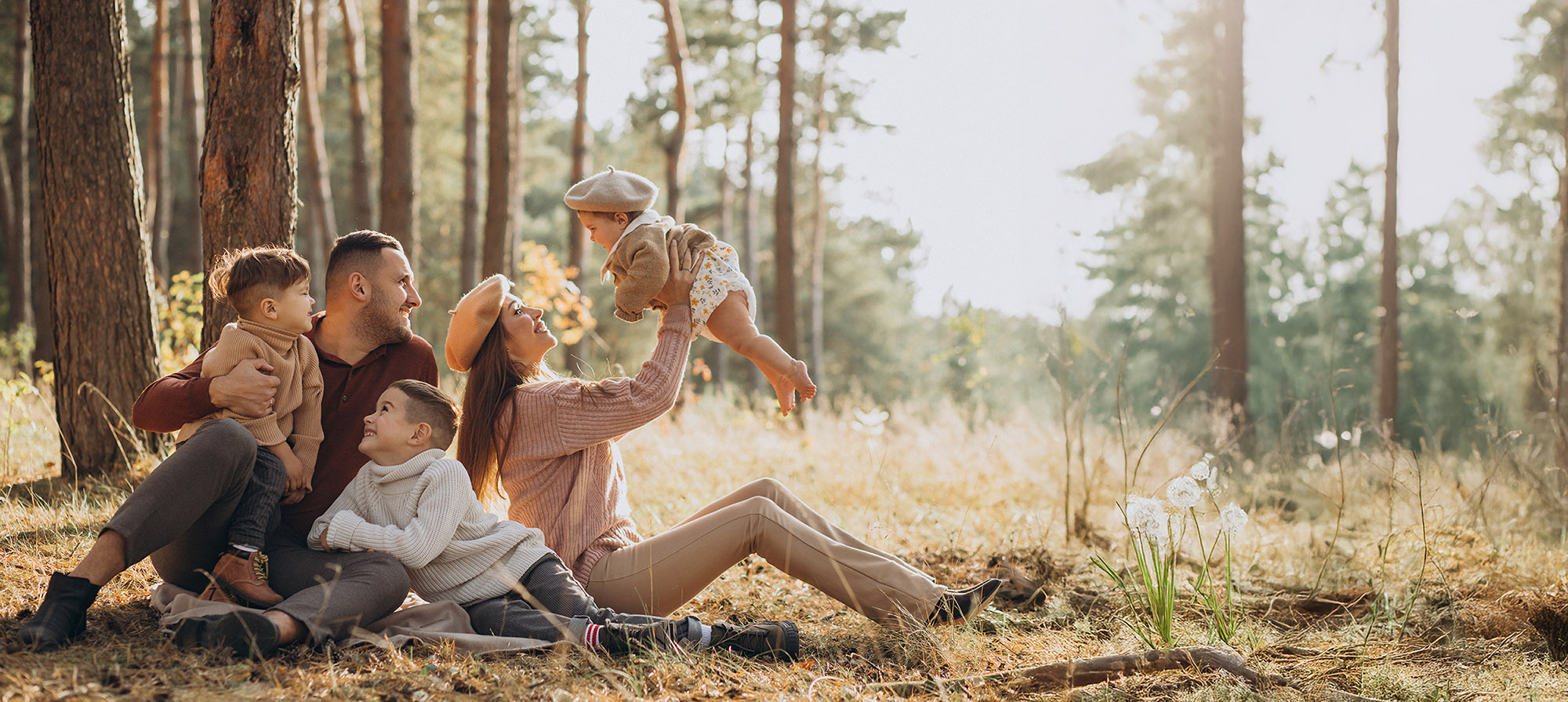 Young family with children having picnic in park